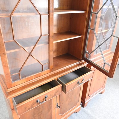Lot 812 - A reproduction yew wood cabinet bookcase,...