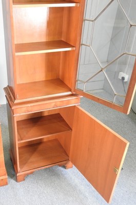 Lot 812 - A reproduction yew wood cabinet bookcase,...
