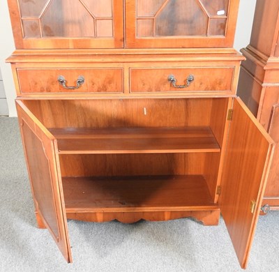 Lot 812 - A reproduction yew wood cabinet bookcase,...