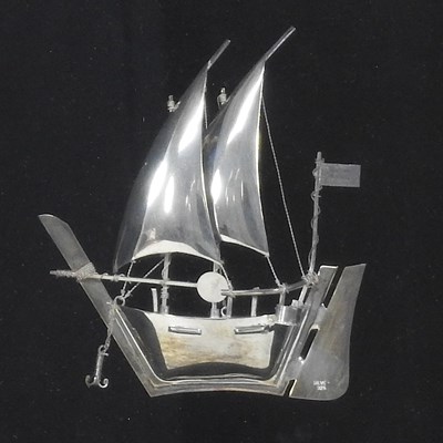 Lot 56 - A silver model of a junk ship, in a display...