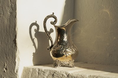 Lot 43 - A Victorian silver jug, repousse decorated...