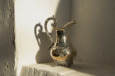 Lot 43 - A Victorian silver jug, repousse decorated...
