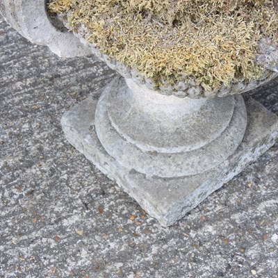 Lot 8 - A pair of weathered cast stone garden urns,...
