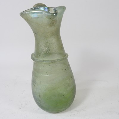 Lot 37 - An ancient green glass pitcher, with an...