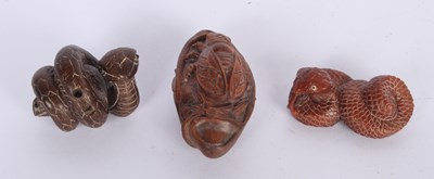 Lot 165 - A collection of three Japanese carved wood...