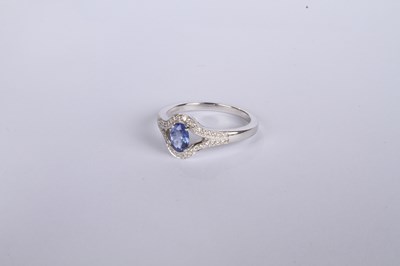 Lot 24 - An 18 carat white gold tanzanite and diamond...