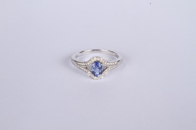 Lot 24 - An 18 carat white gold tanzanite and diamond...