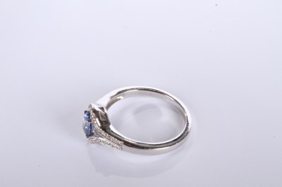 Lot 24 - An 18 carat white gold tanzanite and diamond...
