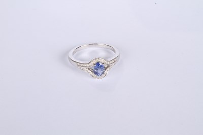 Lot 24 - An 18 carat white gold tanzanite and diamond...