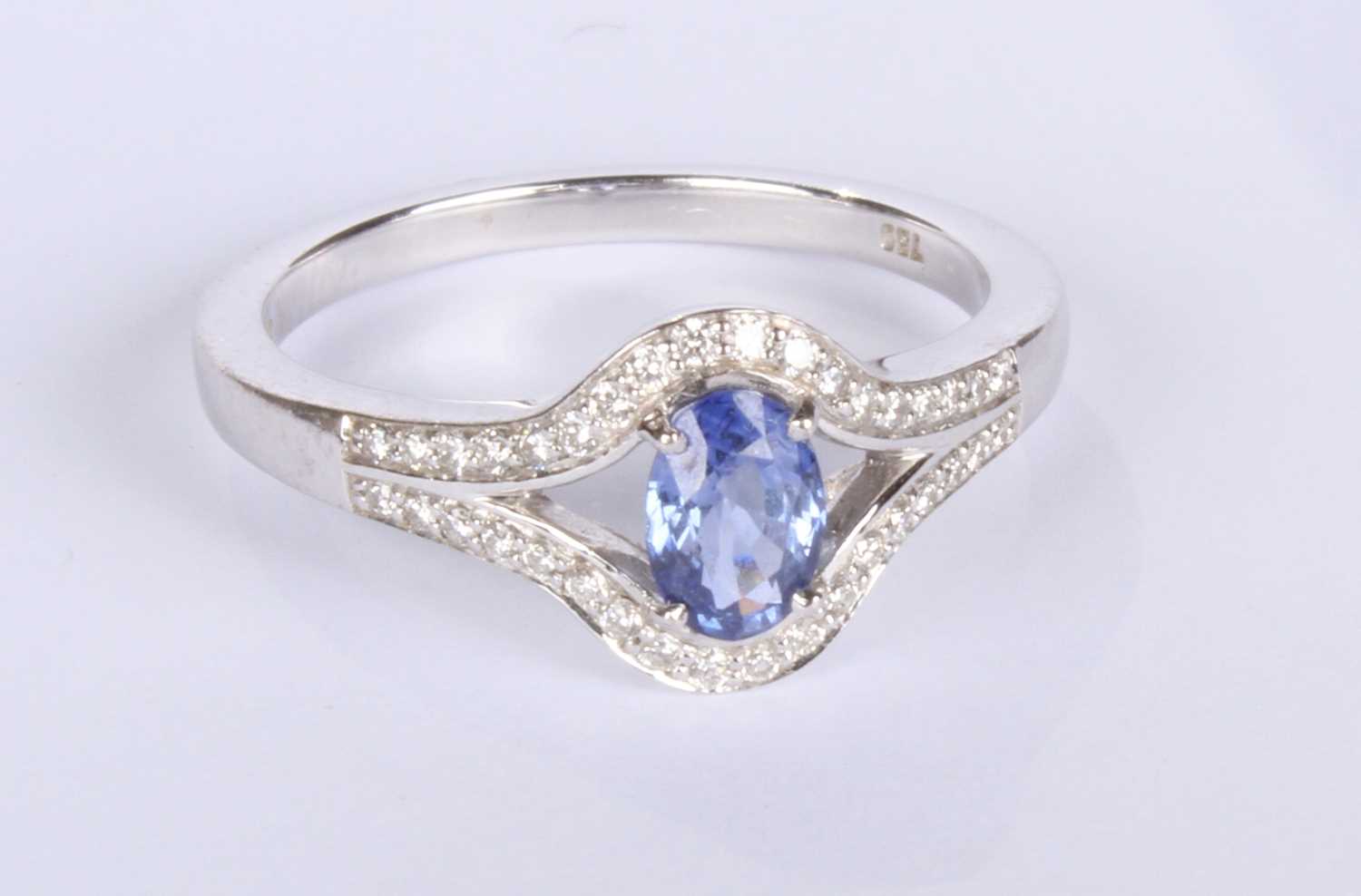 Lot 24 - An 18 carat white gold tanzanite and diamond...