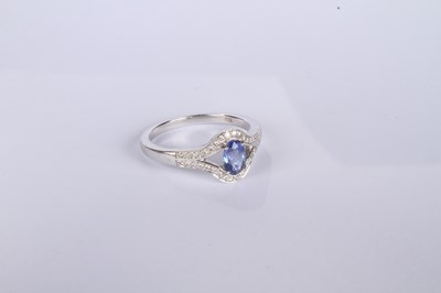 Lot 24 - An 18 carat white gold tanzanite and diamond...