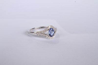 Lot 24 - An 18 carat white gold tanzanite and diamond...