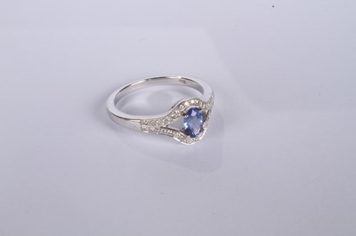 Lot 24 - An 18 carat white gold tanzanite and diamond...