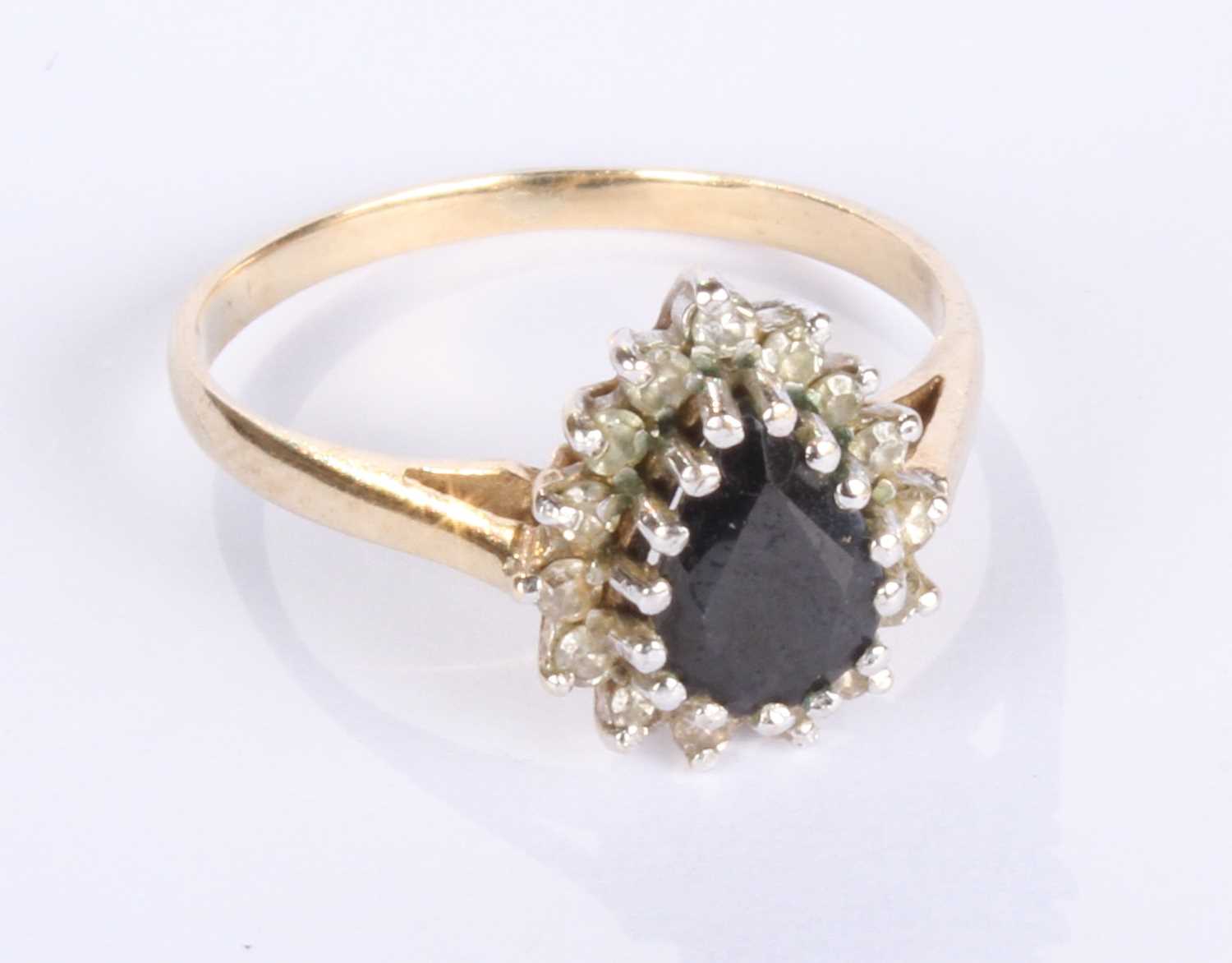 Lot 12 - A 9 carat yellow gold pear shaped sapphire and...