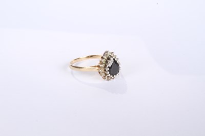 Lot 12 - A 9 carat yellow gold pear shaped sapphire and...
