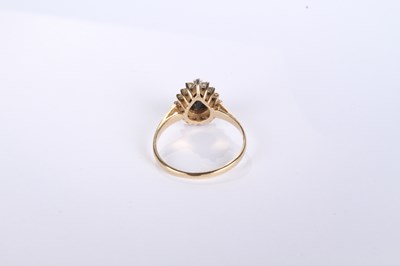 Lot 12 - A 9 carat yellow gold pear shaped sapphire and...
