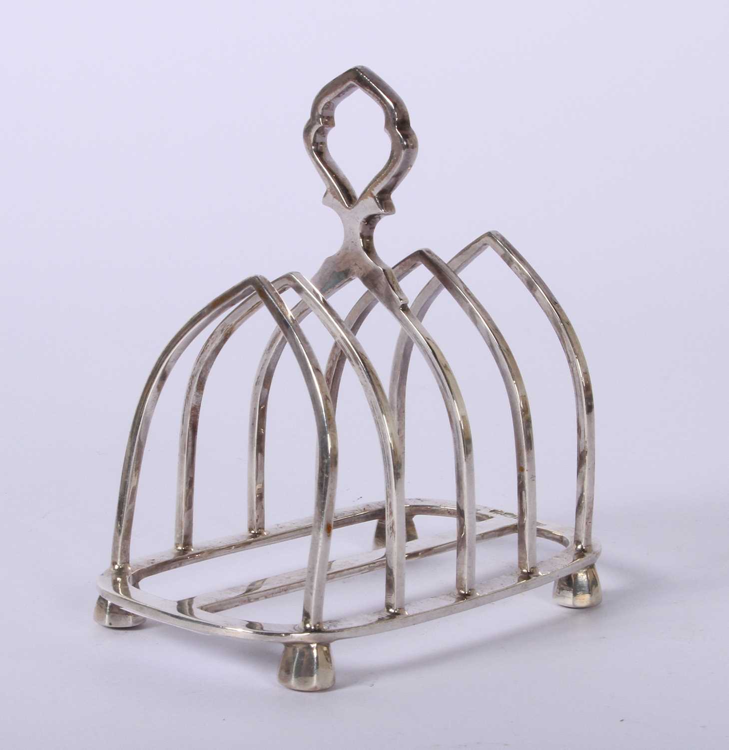 Lot 45 - A George VI silver four division toast rack,...