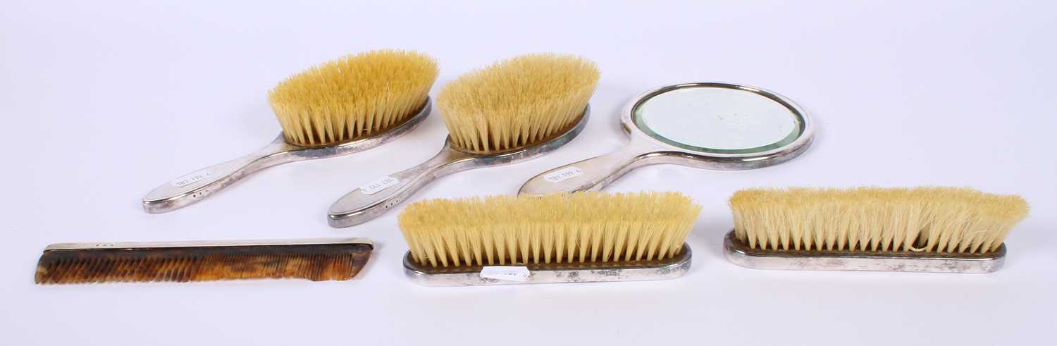 Lot 46 - A George V silver-backed six piece dressing...
