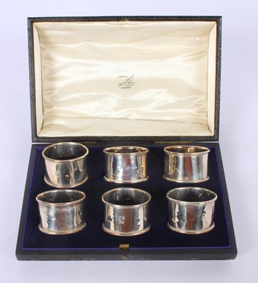 Lot 55 - A set of six silver napkin rings, marks rubbed,...