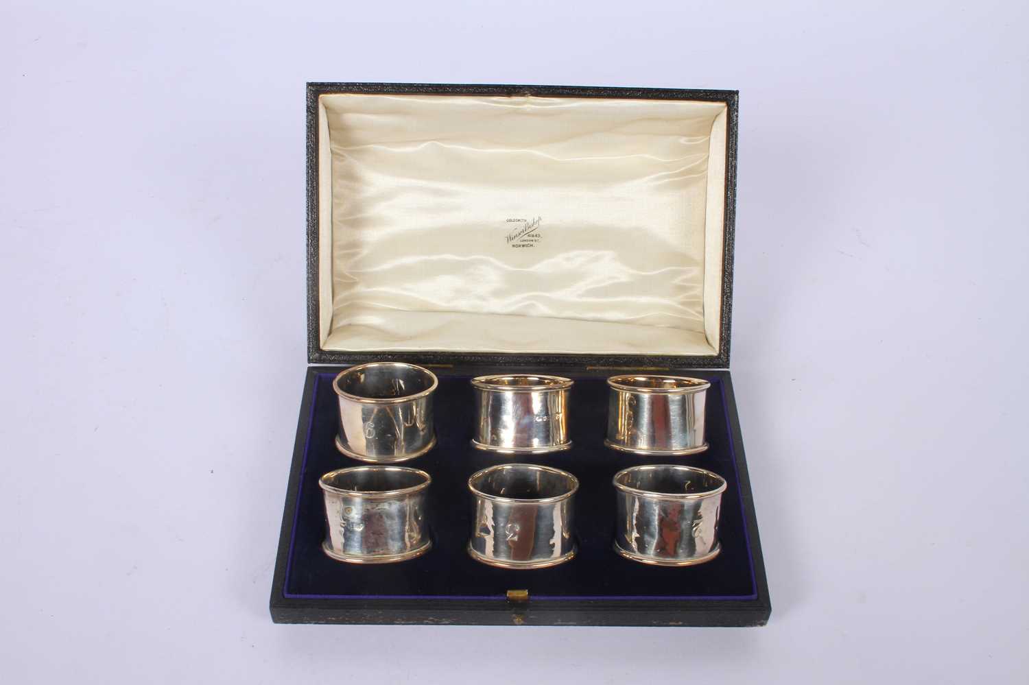 Lot 55 - A set of six silver napkin rings, marks rubbed,...