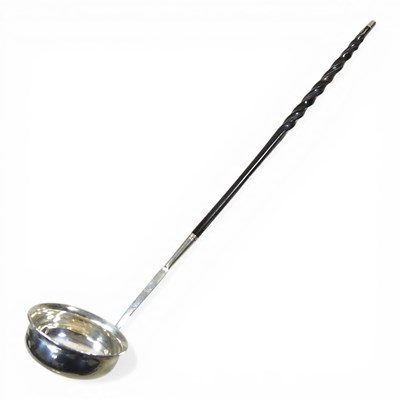 Lot 144 - A George III metalwares toddy ladle, with a...