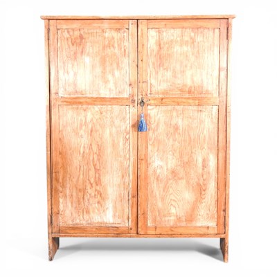 Lot 720 - A rustic antique pine cupboard, enclosed by a...