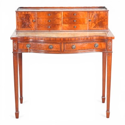 Lot 464 - A reproduction serpentine writing desk, on...