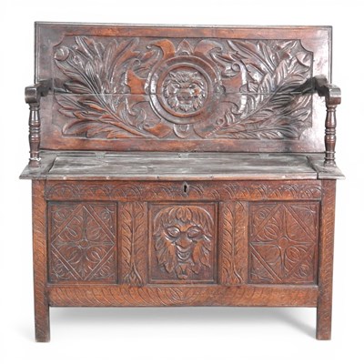 Lot 570 - A 19th century carved oak box settle,...