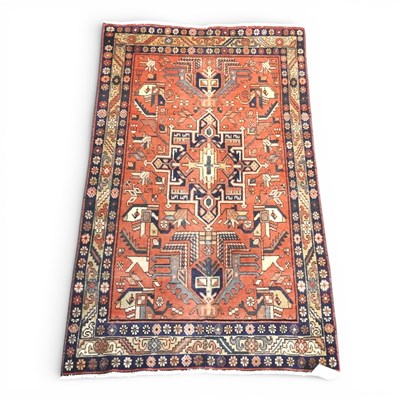 Lot 213 - A Persian Heriz rug, with hooked medallions,...