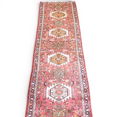 Lot 318 - A Persian Heriz runner, with three central...