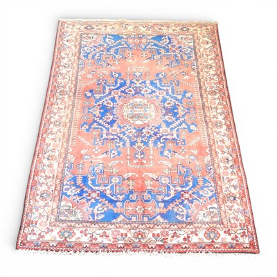 Lot 345 - A Persian rug, with a large central blue...
