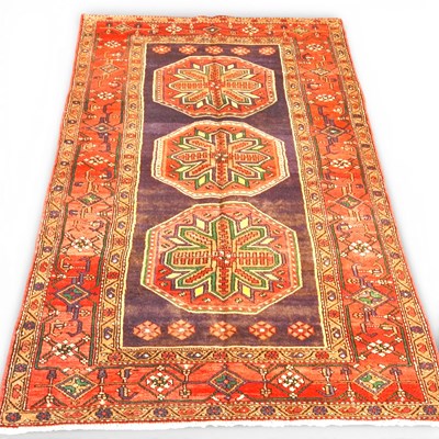Lot 440 - A Persian rug, with three central star...
