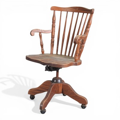 Lot 21 - An early 20th century oak swivel desk chair,...