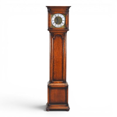 Lot 545 - A 1920s oak longcase clock, having a brass...