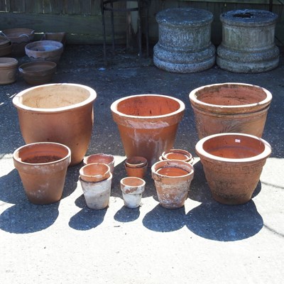 Lot 576 - A collection of terracotta garden pots,...