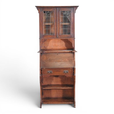Lot 696 - An Arts and Crafts oak lead glazed bureau...