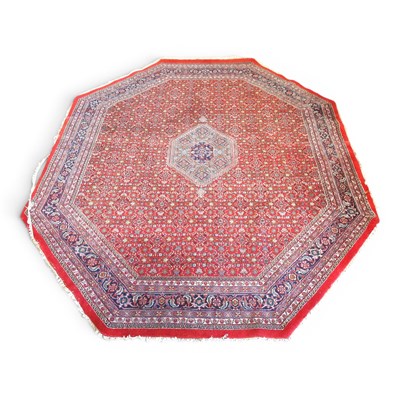 Lot 550 - A large Persian Bidjar rug, of octagonal shape,...