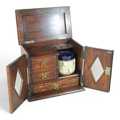 Lot 302 - A 1920s oak smoker's cabinet, with a fitted...