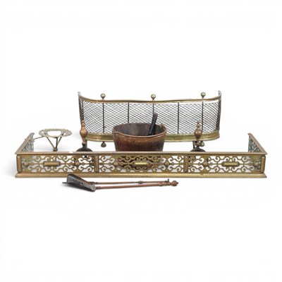 Lot 646 - A 19th century pierced brass fender, together...