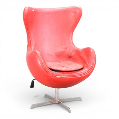 Lot 38 - After Arne Jacobsen a red upholstered swivel...