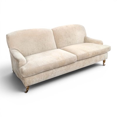 Lot 593 - A large Howard style pale upholstered sofa