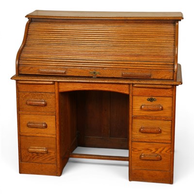 Lot 552 - An early 20th century oak tambour fronted roll...