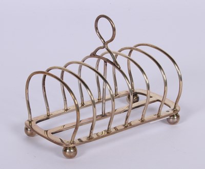 Lot 49 - A George V silver seven division toast rack,...