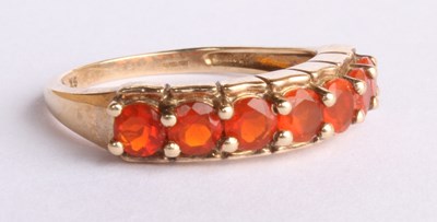 Lot 45 - A 9 carat yellow gold seven stone fire opal...