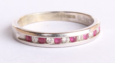 Lot 74 - A 9 carat white gold ruby and diamond half...