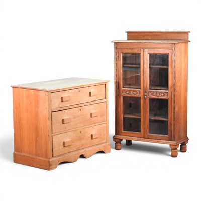 Lot 630 - A 1920s light oak glazed bookcase, together...