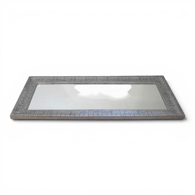 Lot 376 - A large wall mirror, with an embossed metal...