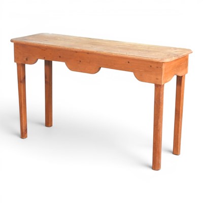 Lot 631 - A rustic pine side table, with a shaped apron,...